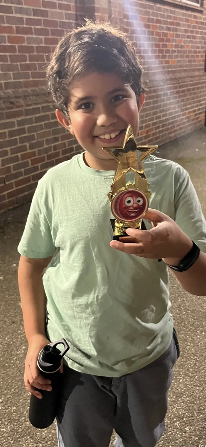 Young player proudly holding an award